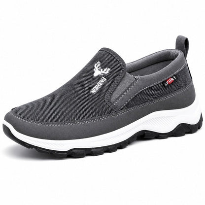 Gråsvarta slip-on-skor med textilovandel, vadderad häl och vit sula