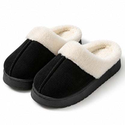 Slip-on-tofflor i svart med vit fuskpäls och tjock mörk sula