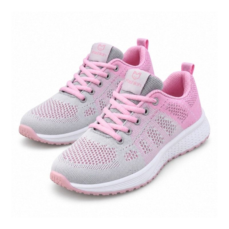 Rosa textilsneakers för dam med snörning och vit sula, mesh framtill.