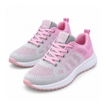 Rosa textilsneakers för dam med snörning och vit sula, mesh framtill.