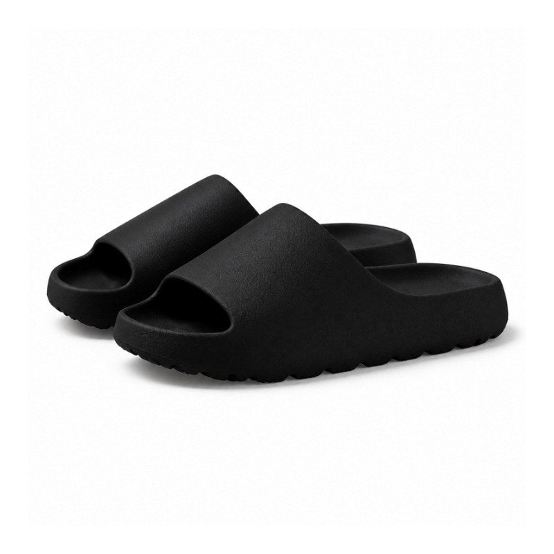 Svarta slip-on-tofflor med kraftig sula och öppen häl