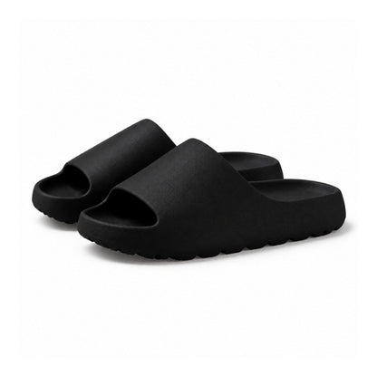 Svarta slip-on-tofflor med kraftig sula och öppen häl