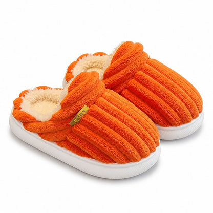 Barnofflor med mjukt fleecefoder i orange, frottéstruktur och vit sula.